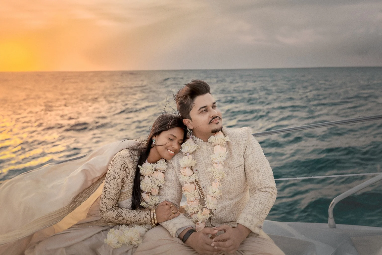 Couple getting married on a yacht wearing Indian Traditional Sherwani and Saree in Arabian Sea blu 2