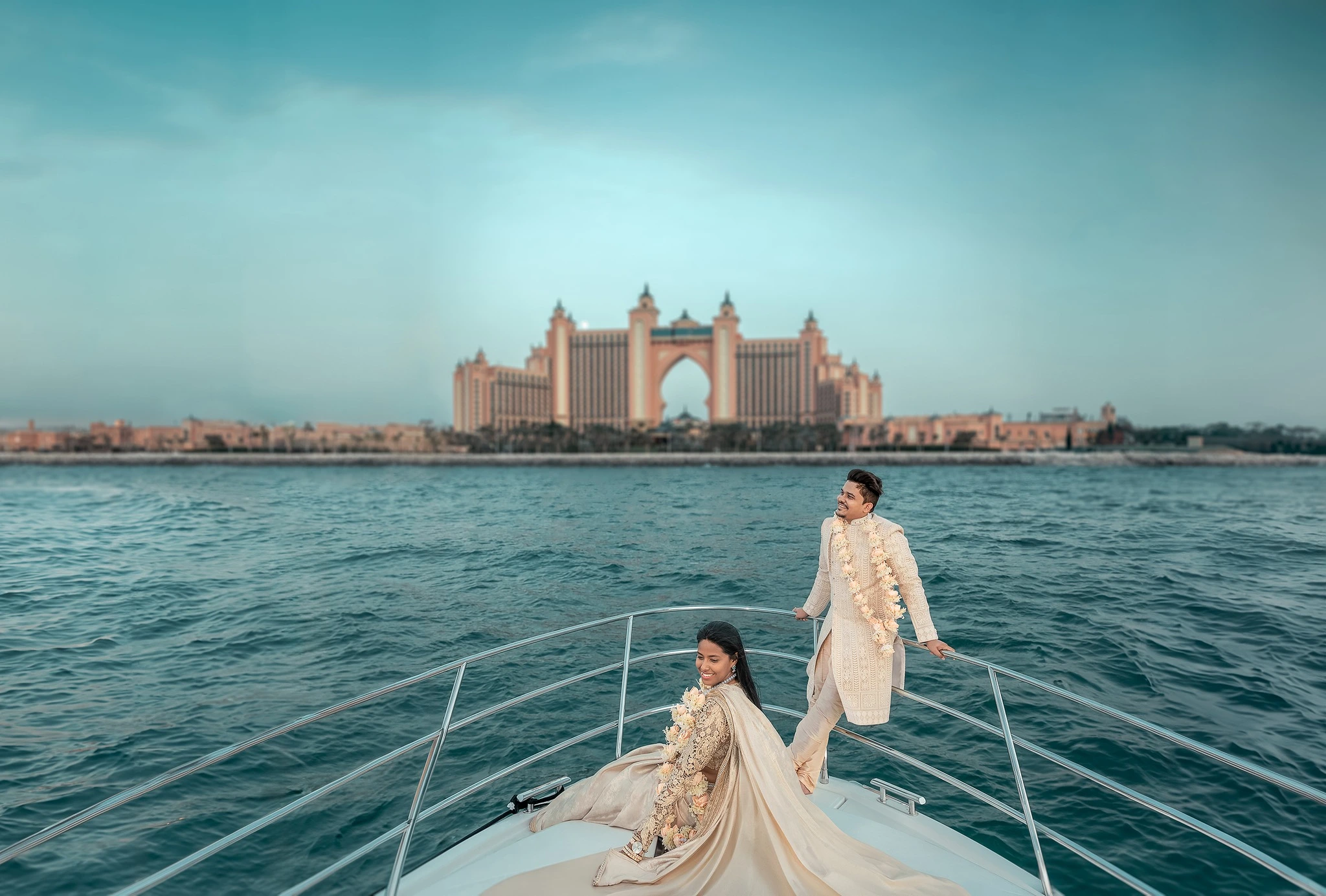 Couple getting married on a yacht wearing Indian Traditional Sherwani and Saree in Arabian Sea blu 1